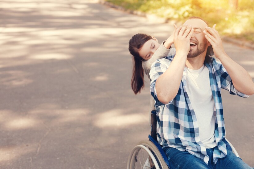 man in wheelchair with child on a gravel path